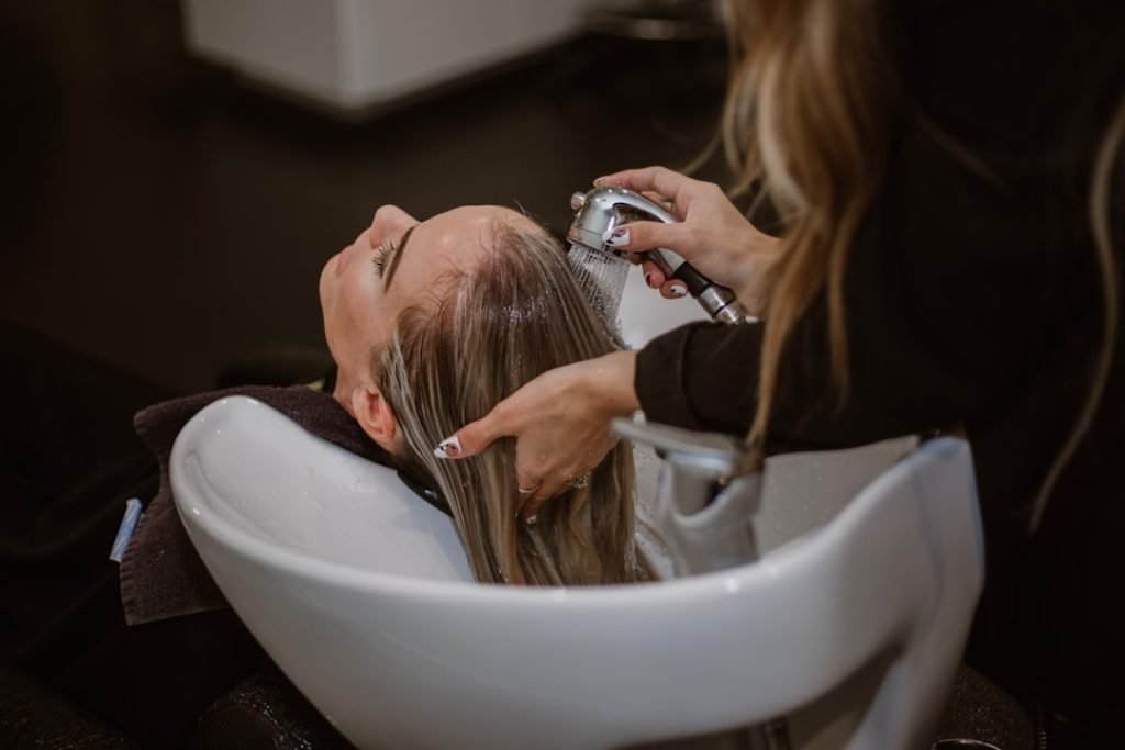 a-woman-getting-her-hair-cut-by-a-hair-stylist-md-dhafsncq